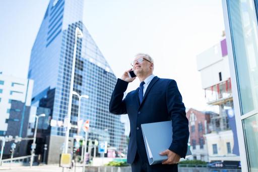 A man wearing suit talking on the phone